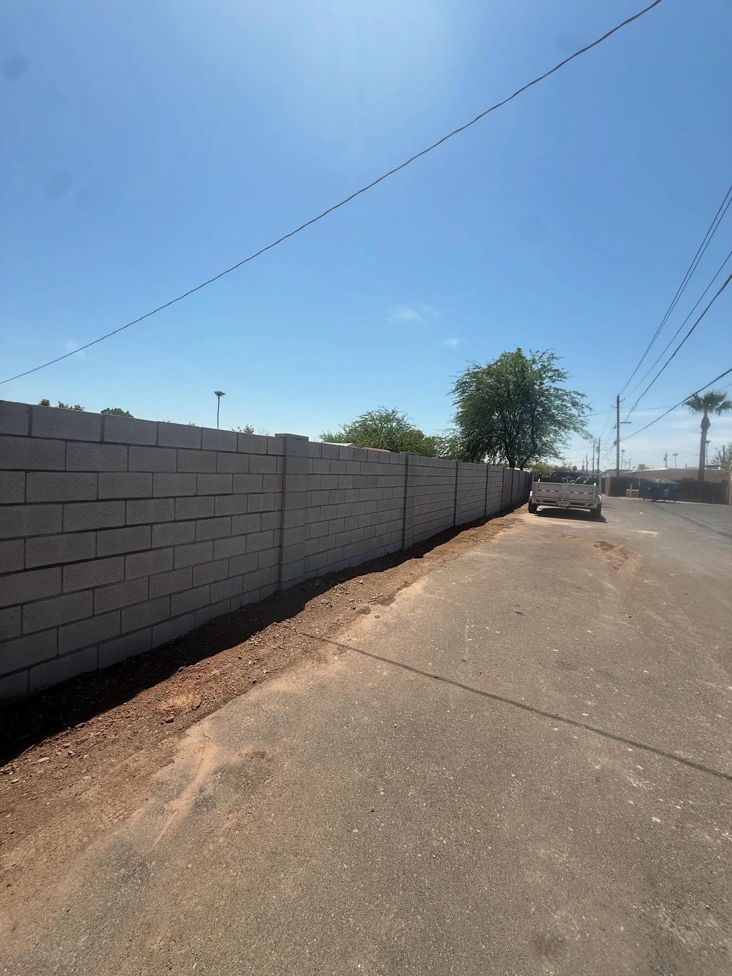 Long run of new block fence wall along a Phoenix, Arizona street